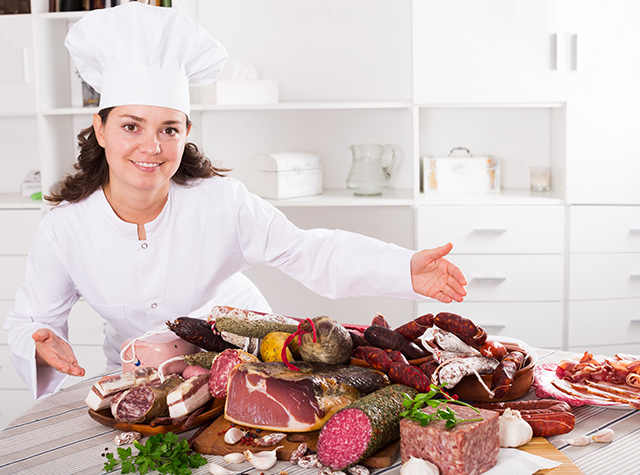 Girl shows sausages and smoked products